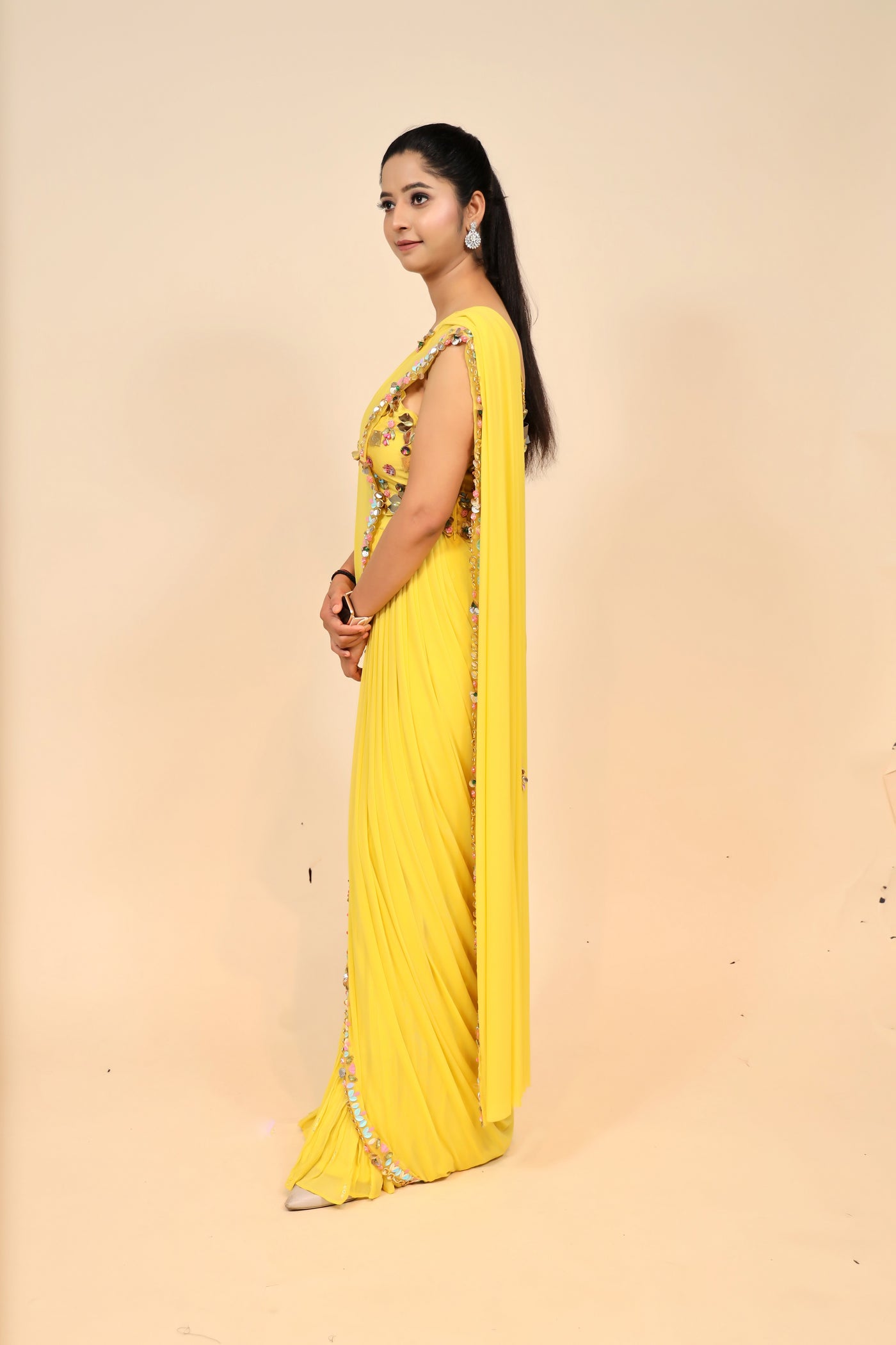 woman posing in yellow chiffon dress