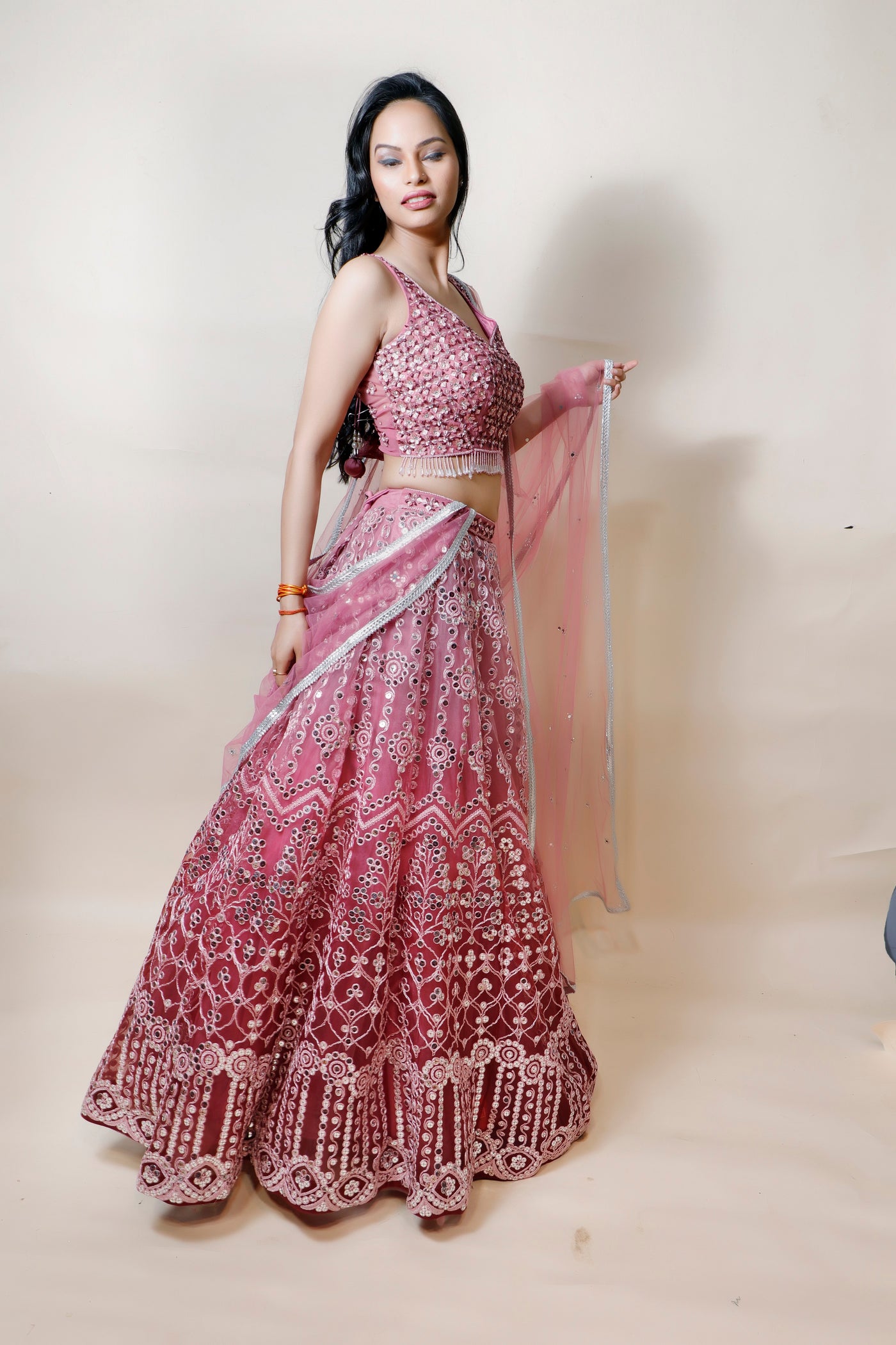 woman wearing pink net lehenga