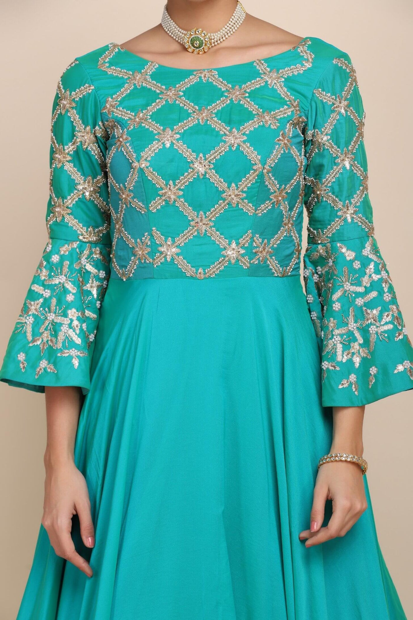 closer look showing details of turquoise dress