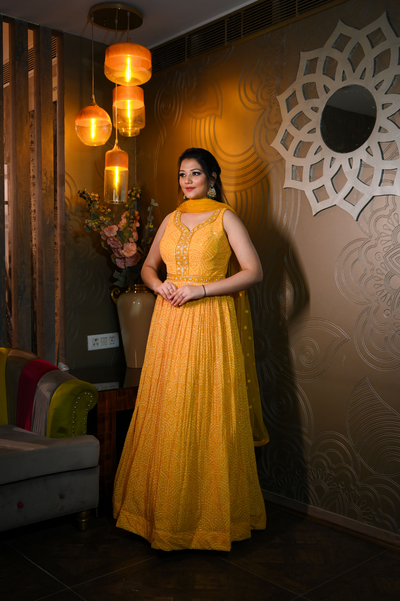 Woman wearing yellow bandhej dress