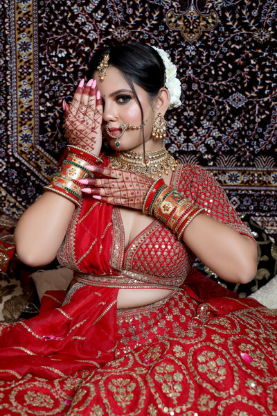 closer look of woman posing in red raw silk lehenga