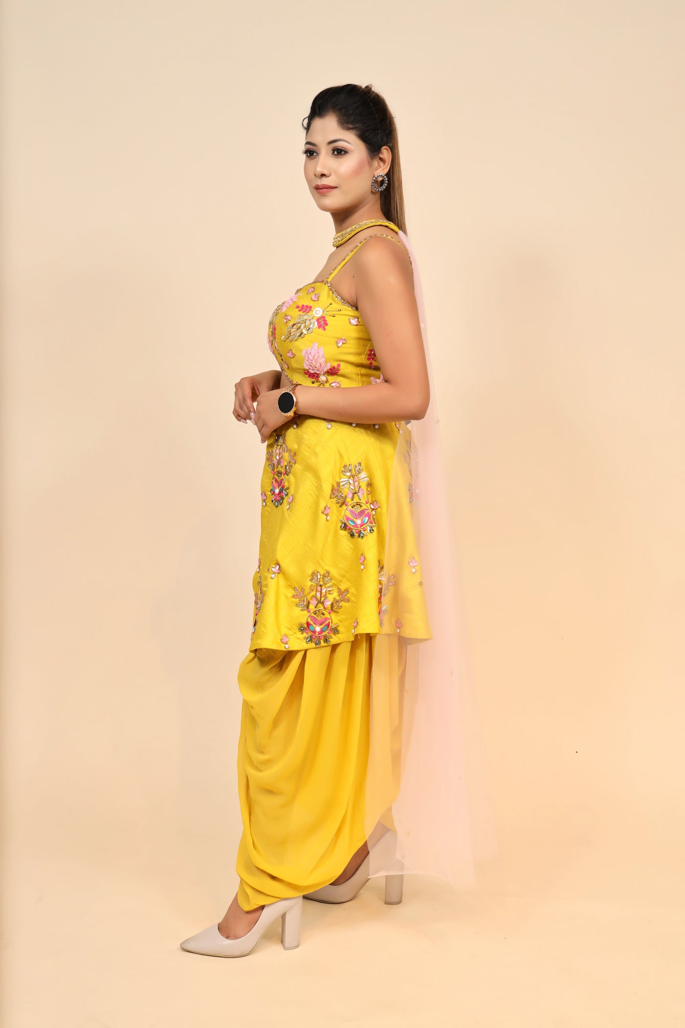 model side posing wearing mustard yellow silk dress