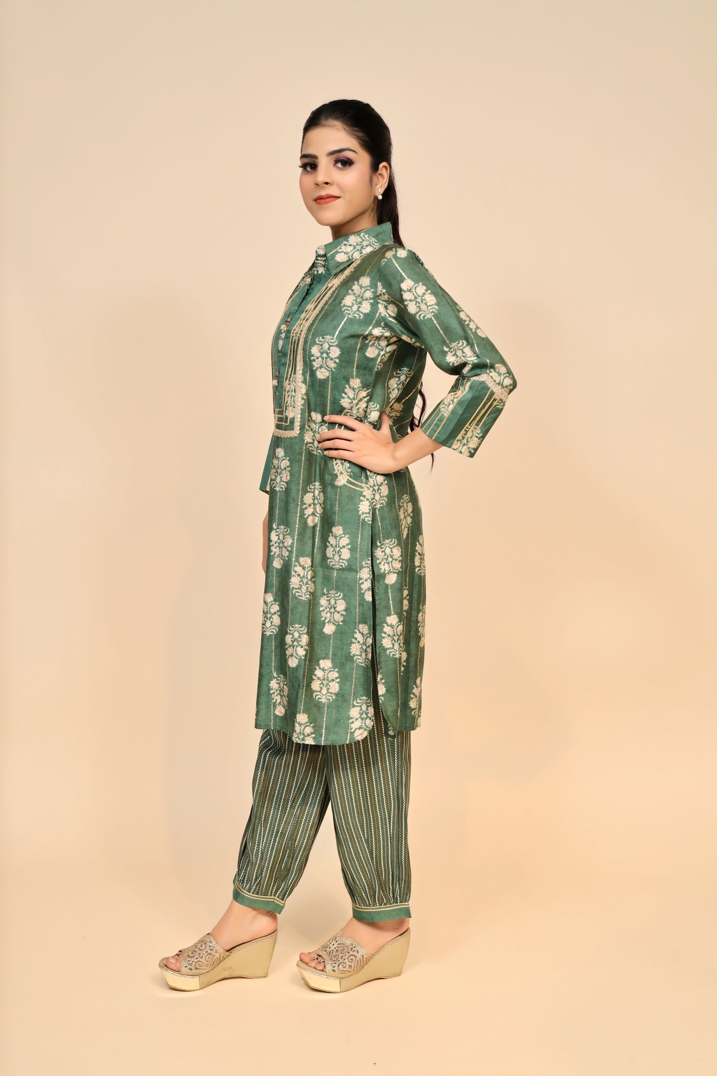 model posing wearing green silk kurti