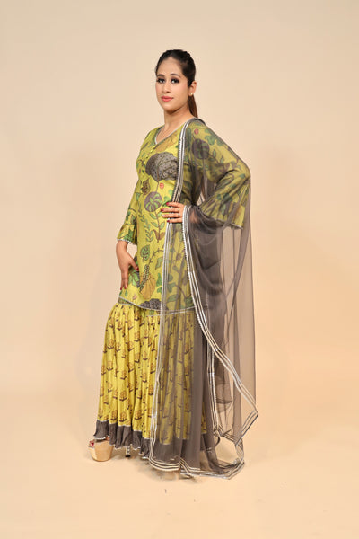 model posing wearing yellow muslin kurti