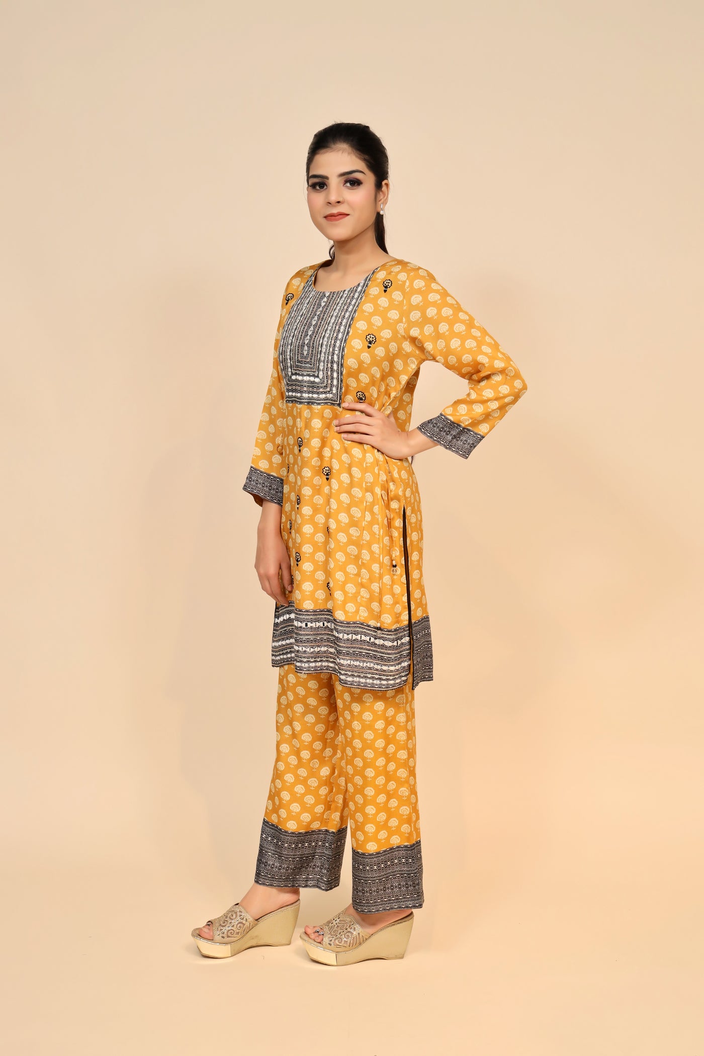 model posing wearing yellow silk blend kurti