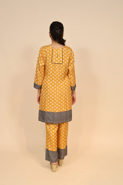 full back look of yellow silk blend kurti