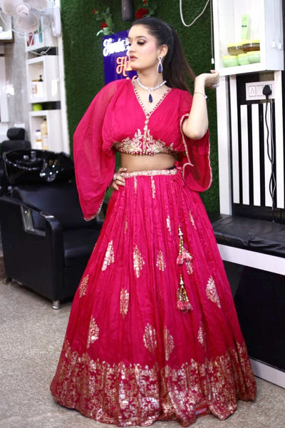 model posing wearing pink georgette lehenga