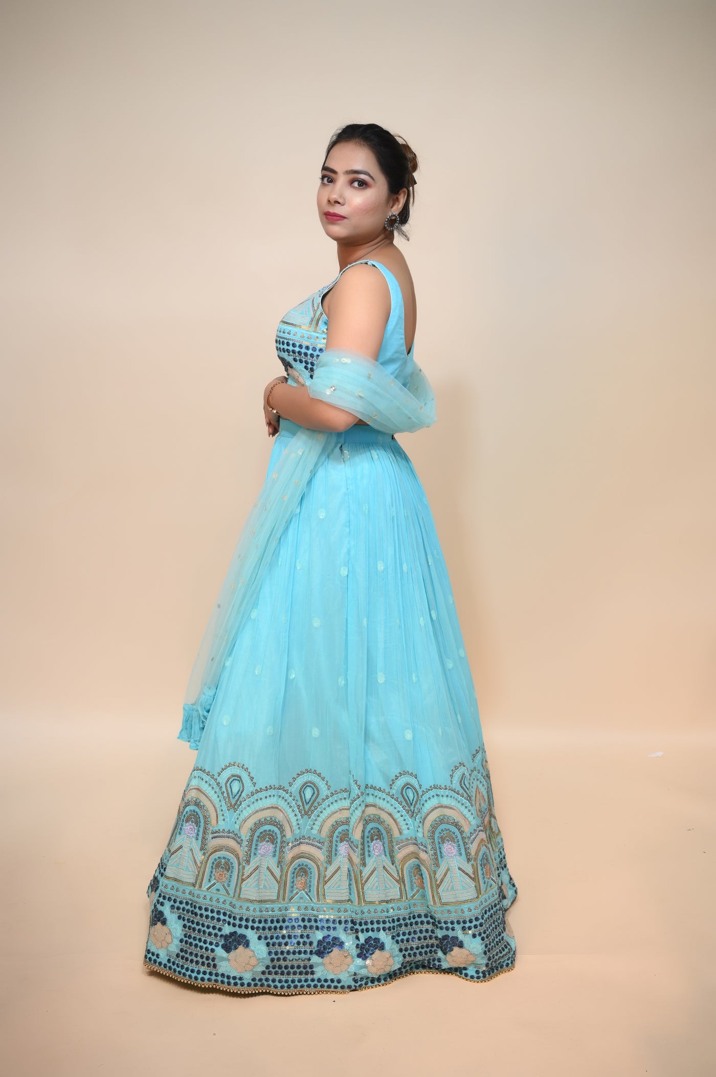 model posing wearing sky blue net lehenga