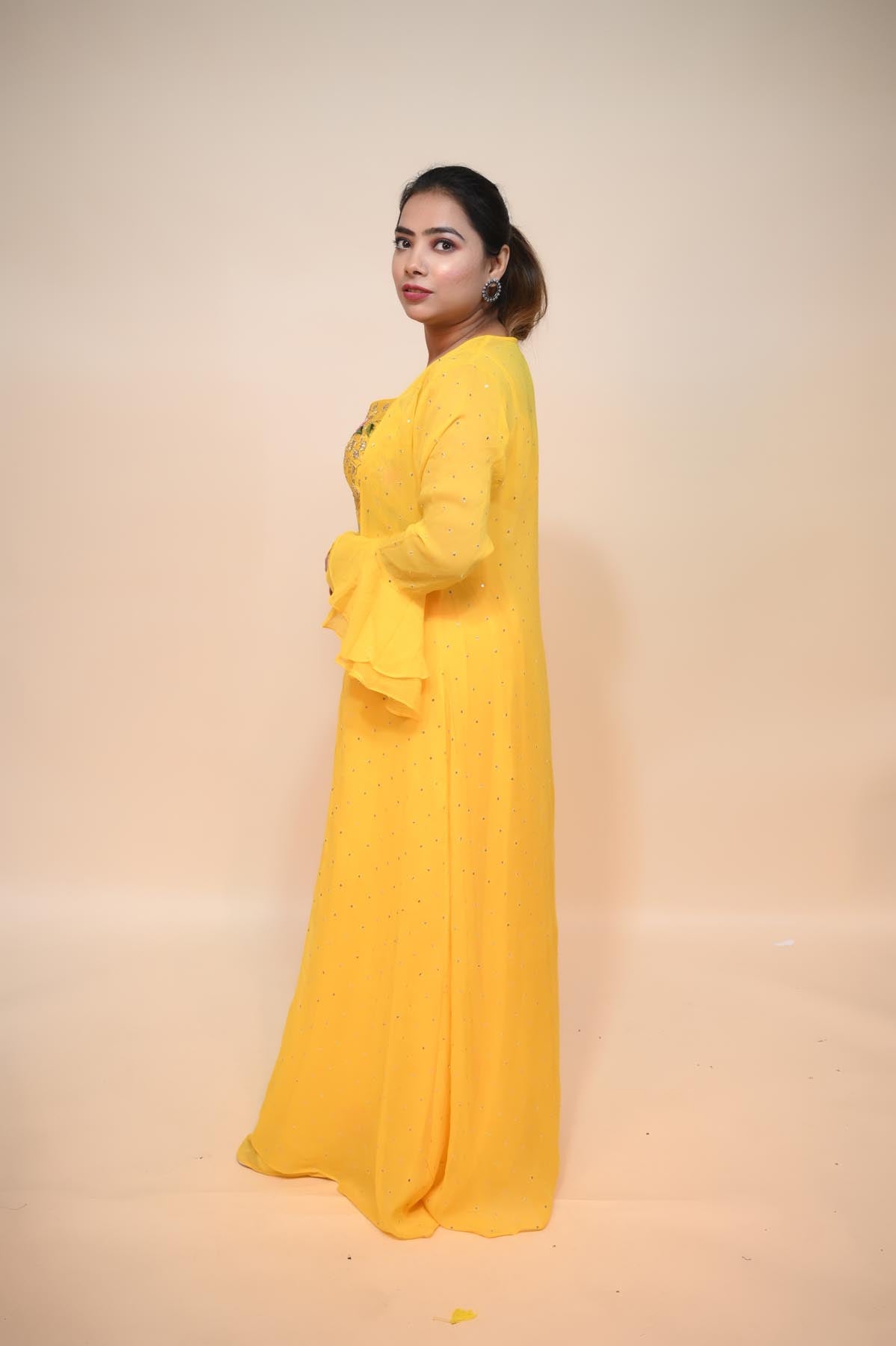 model posing wearing yellow silk blend dress