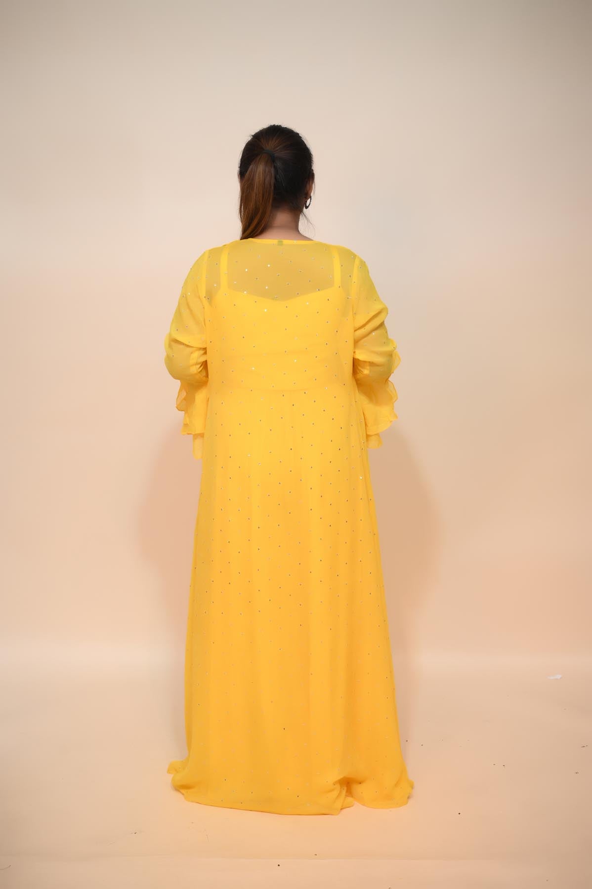 full back look of yellow silk blend dress