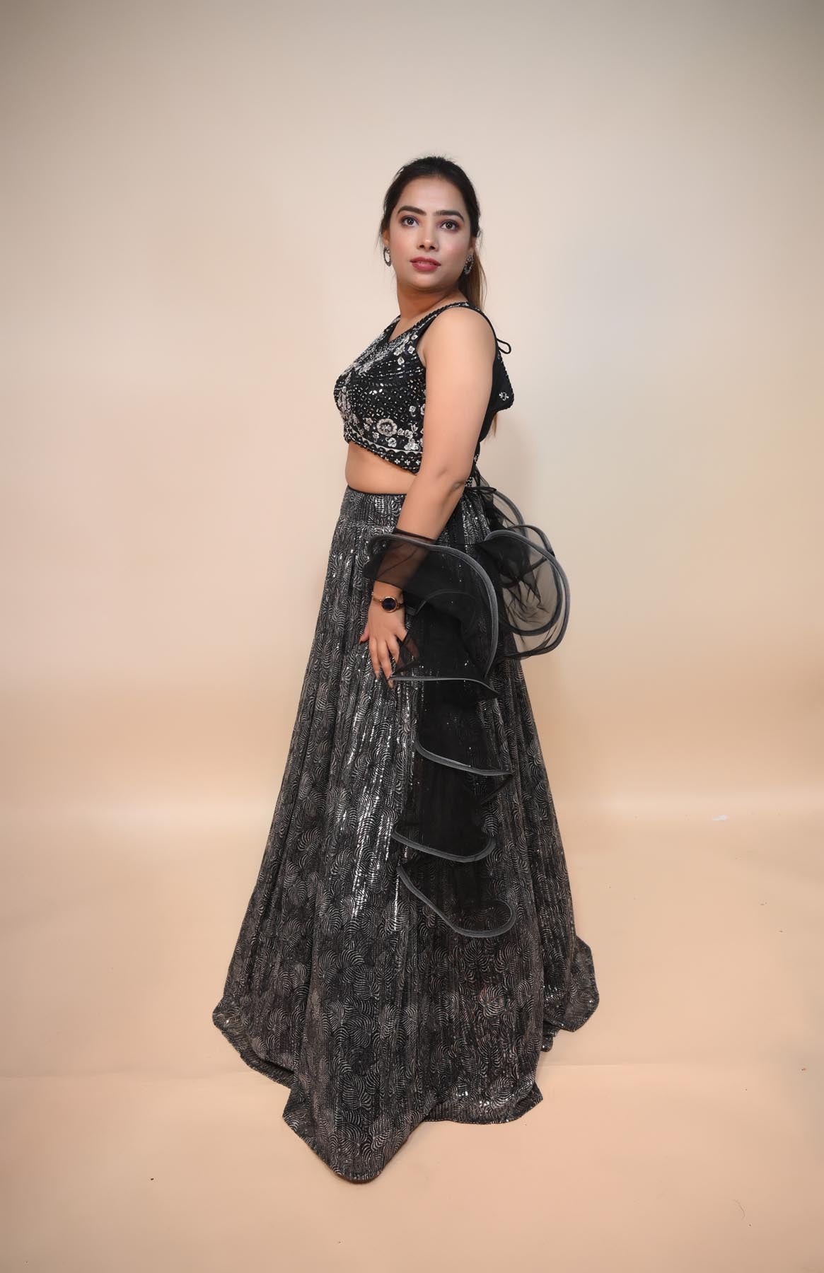 model posing wearing back silk blend lehenga