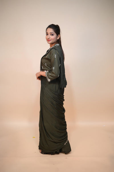 model posing in mehndi green silk dress