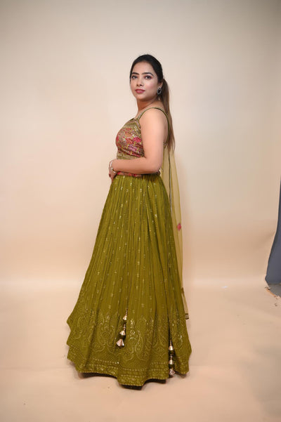 model posing wearing mehndi green georgette lehenga