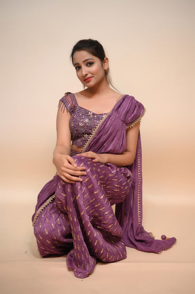 woman sitting wearing purple net saree