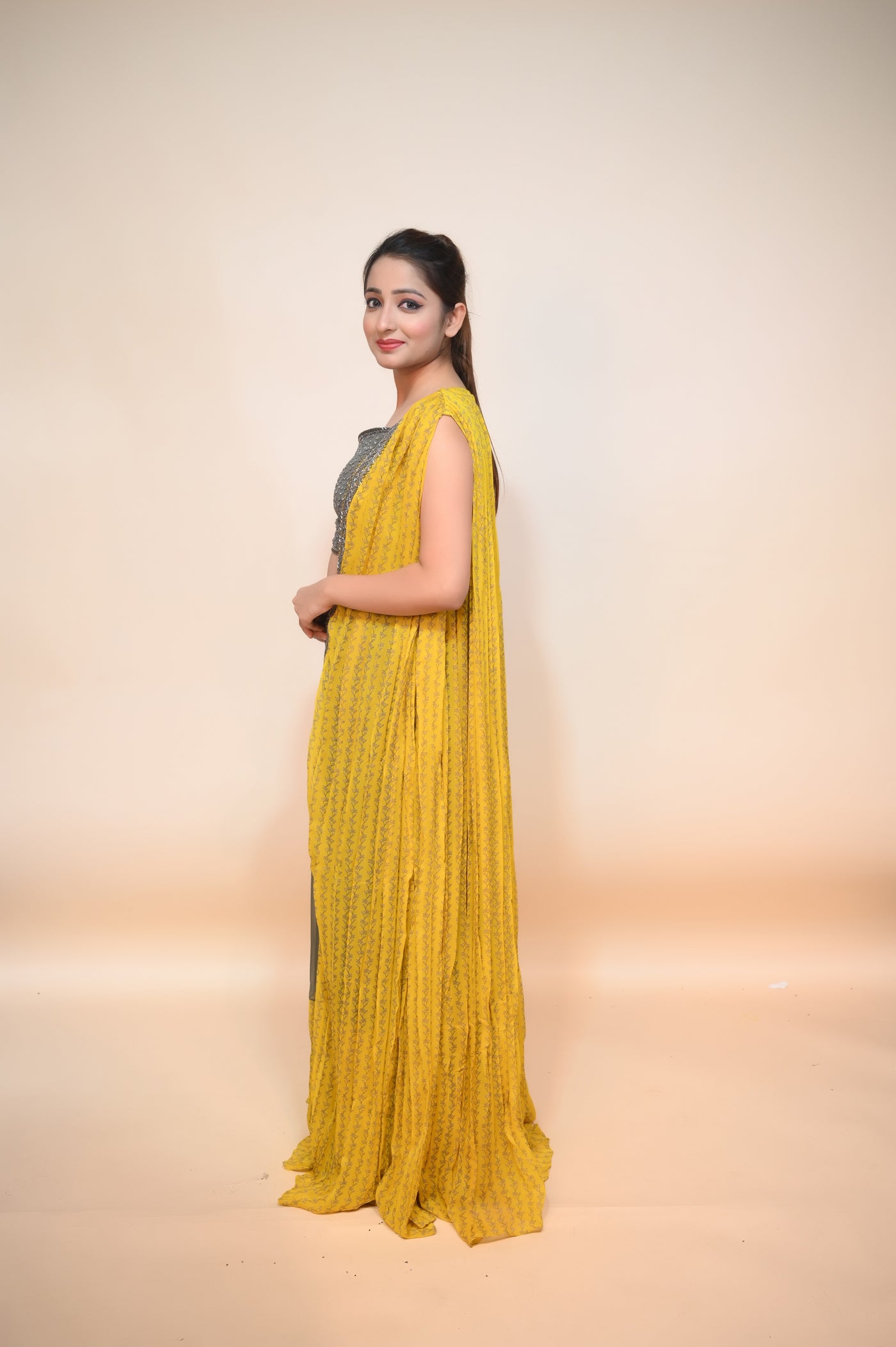 model side posing in green and yellow georgette dress