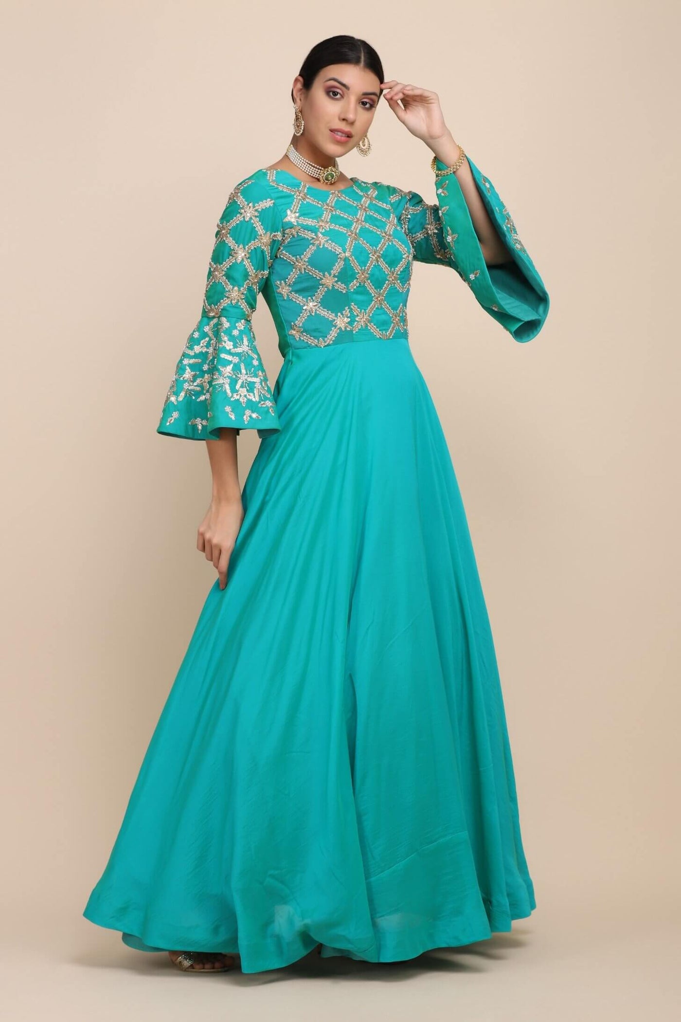 model posing wearing turquoise dress