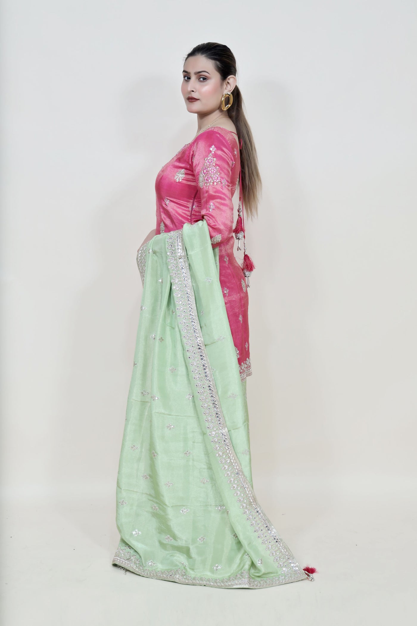 Girl Wearing a Majenta & Green Color Floral Motif Sharara Set