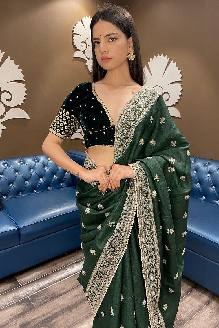Classic green color floral motif embroidered saree with broad border and buttis with matching blouse