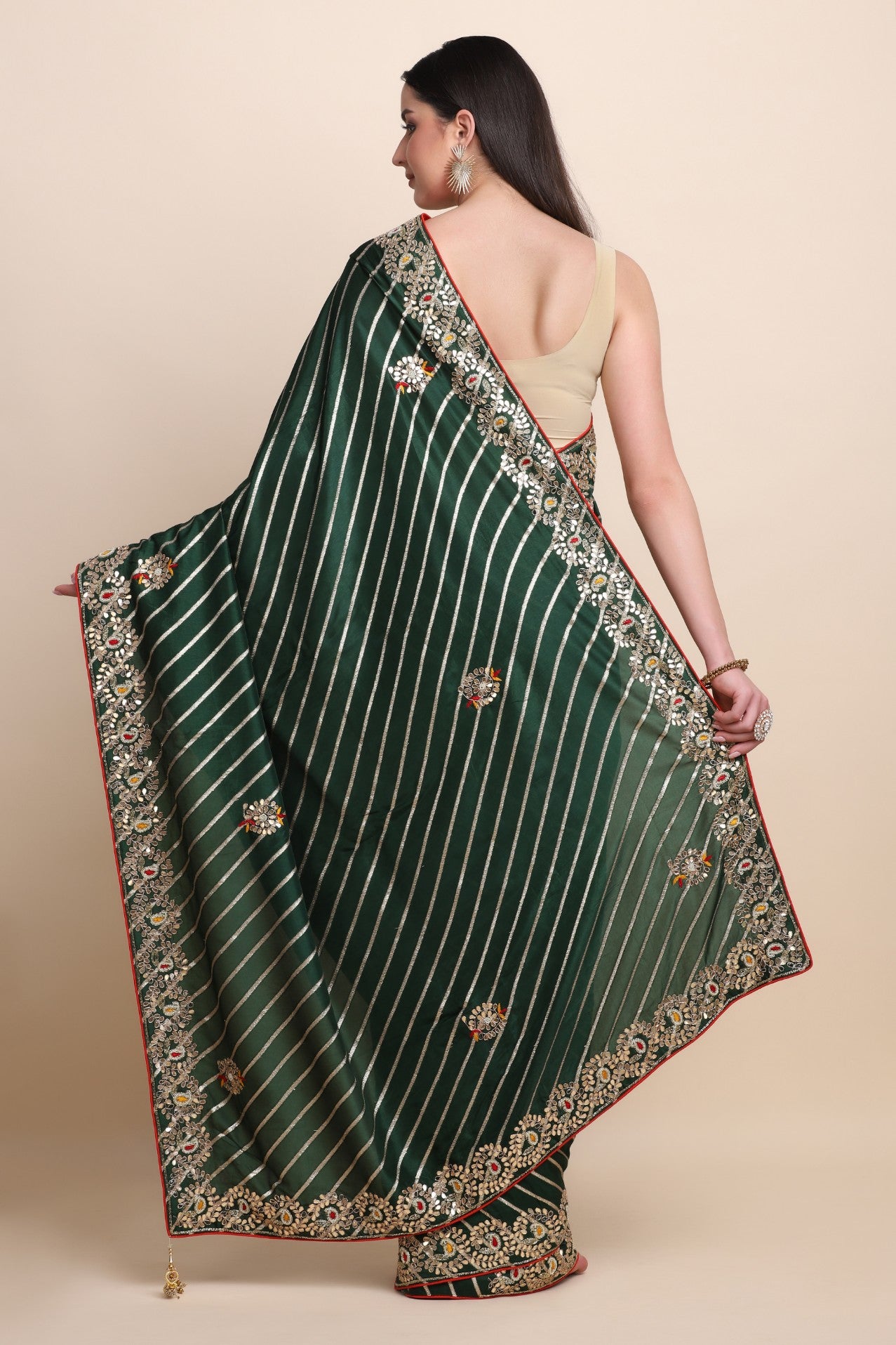 Beautiful green color floral motif embroidered diagonal zari strips woven saree paired with a matching blouse