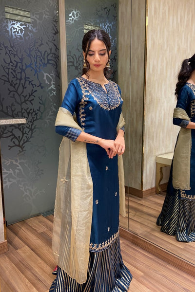 model posing in blue floral motif kurti