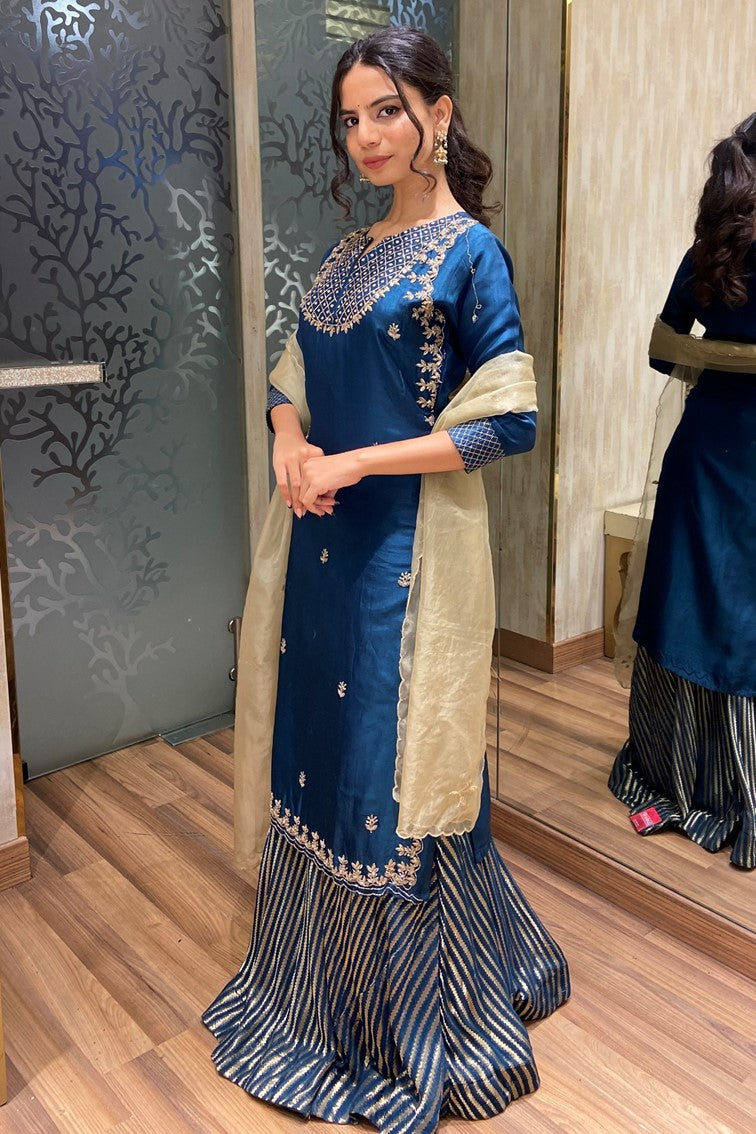 model side posing wearing blue floral motif kurti