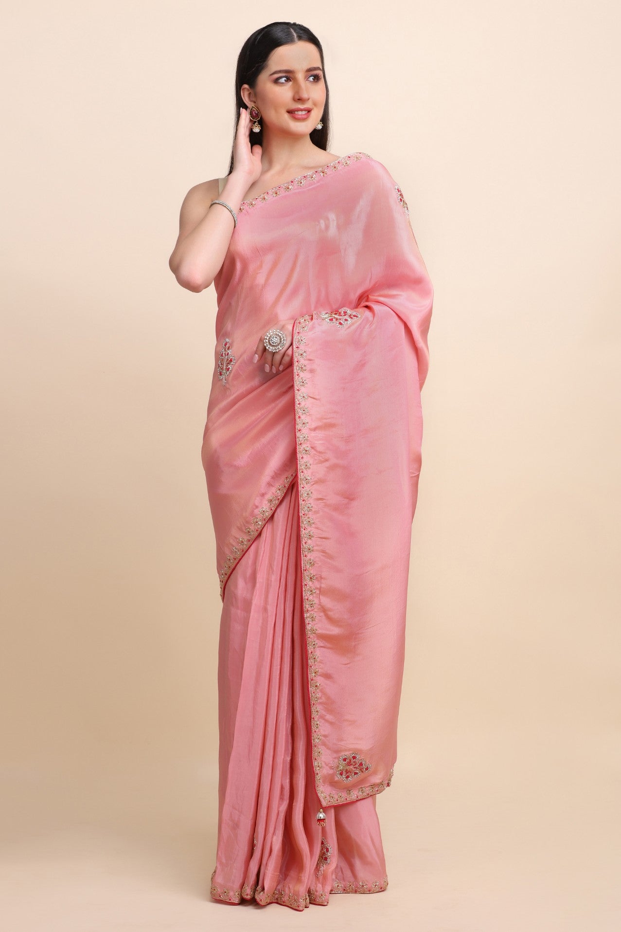 woman posing in pink embroidered saree