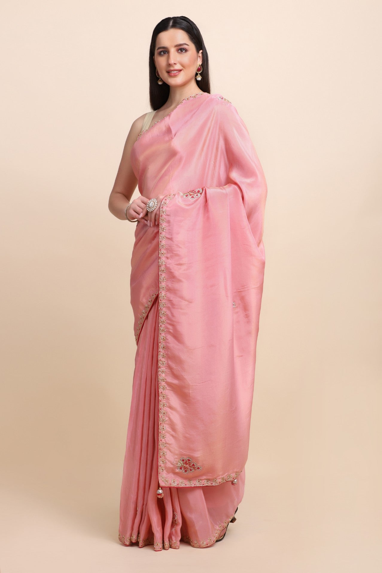 woman standing in pink embroidered saree
