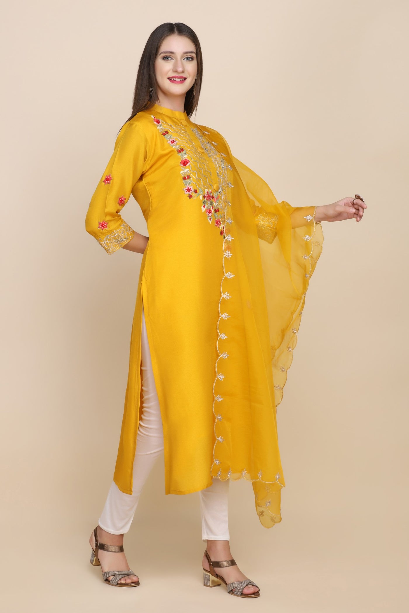 model posing wearing yellow embroidered kurti