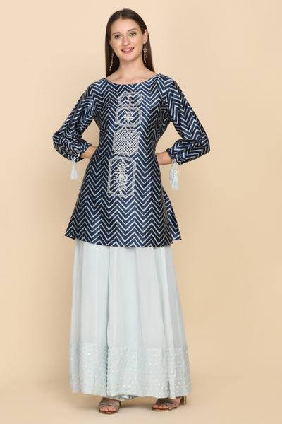 woman standing wearing blue embroidered kurti set
