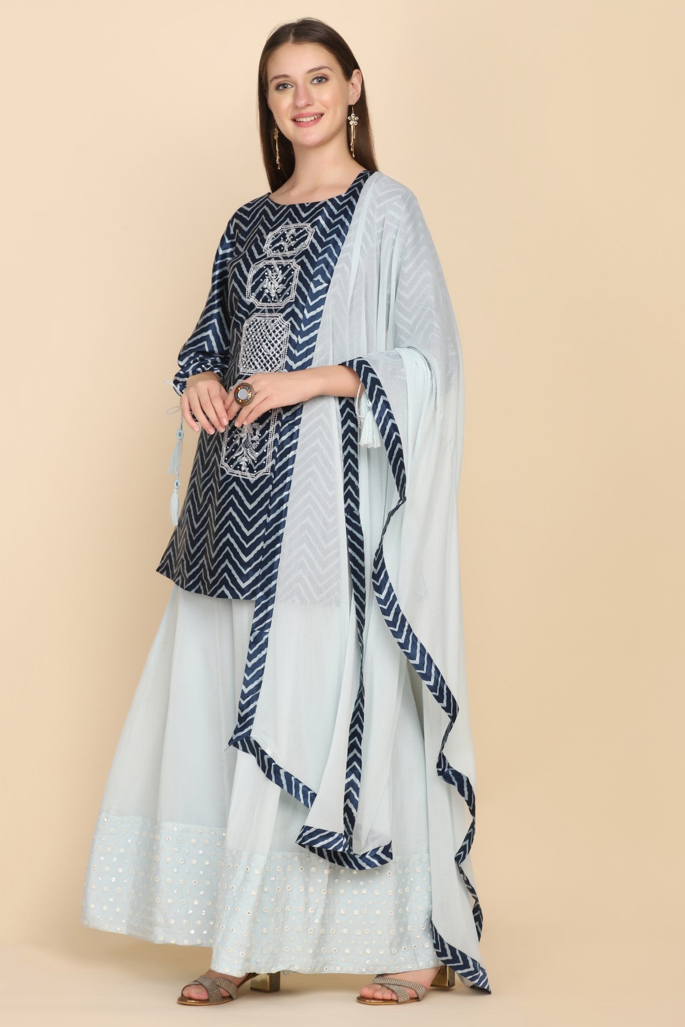 model wearing blue embroidered kurti set