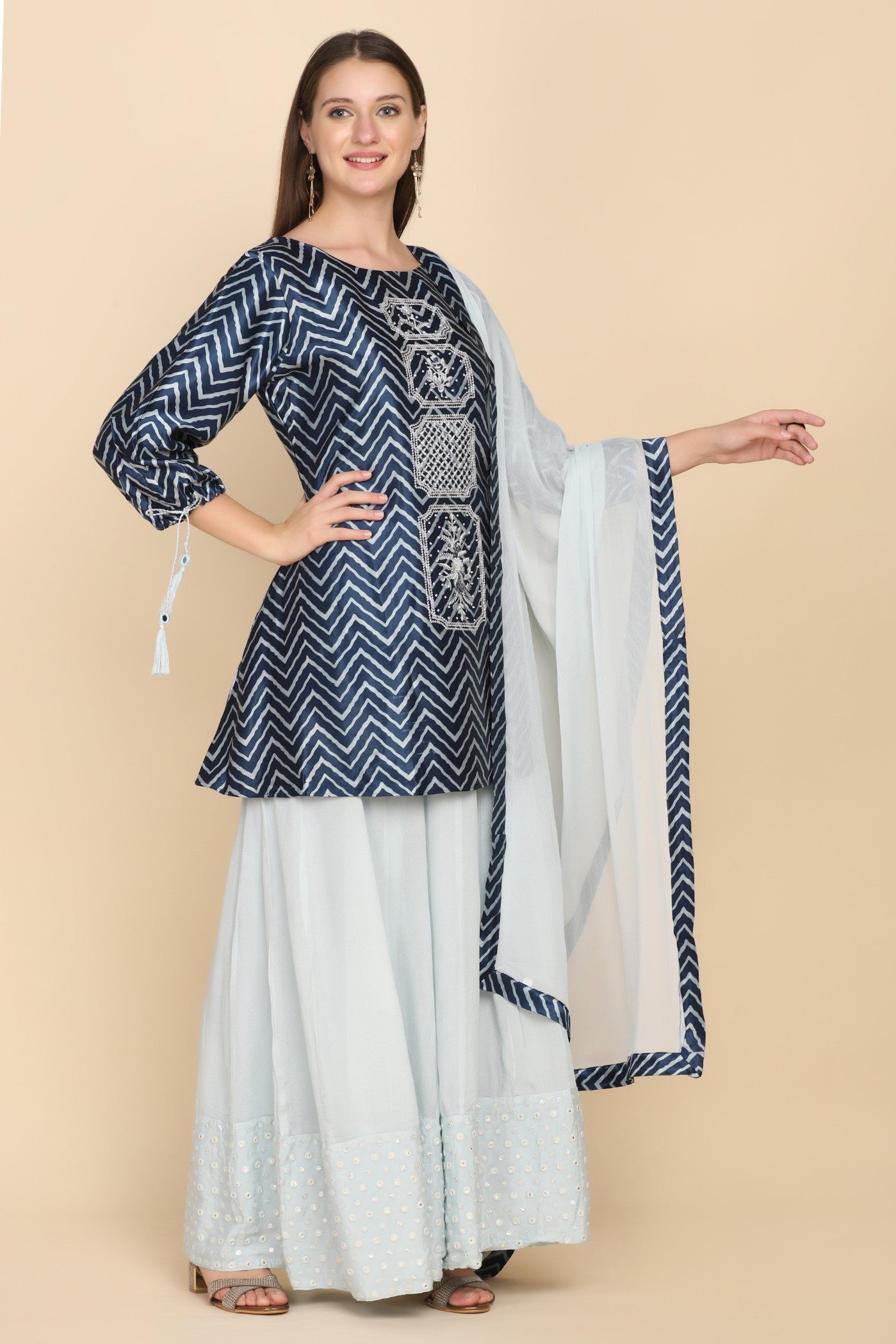 model posing wearing blue embroidered kurti set