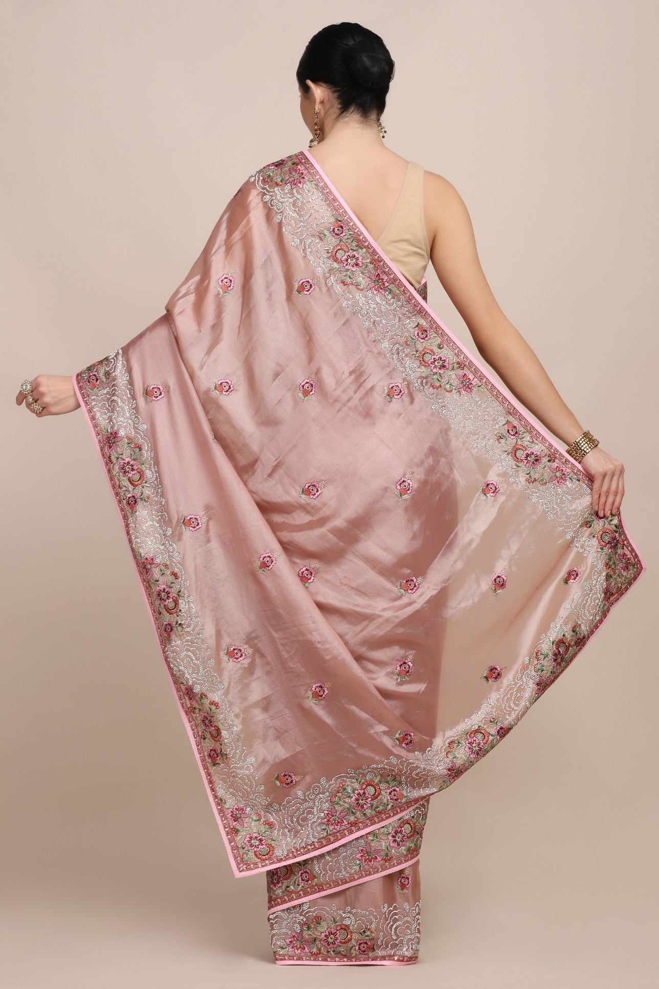back view of woman in Onion pink floral embroidered saree