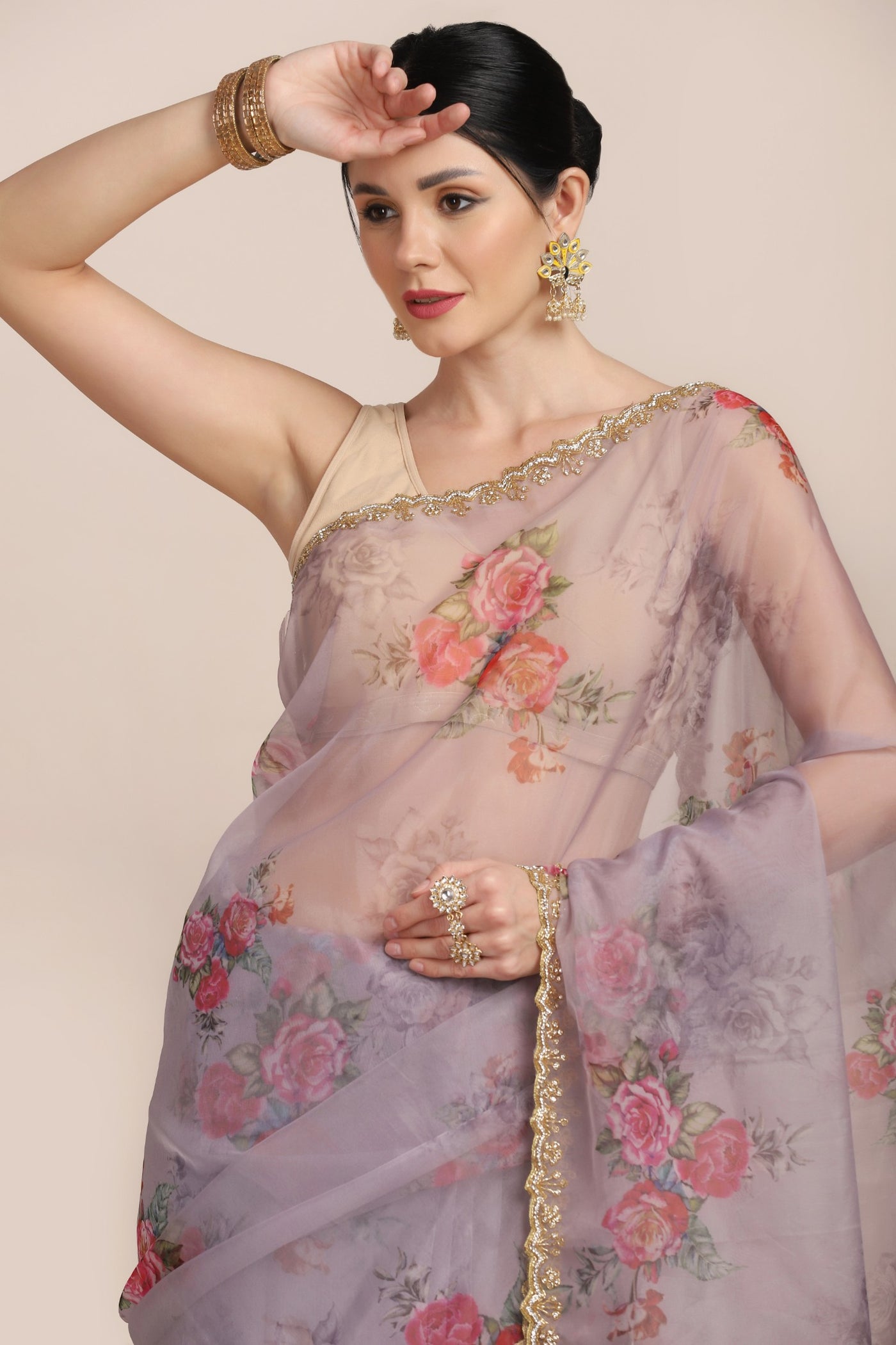 closer look of woman posing in floral printed saree