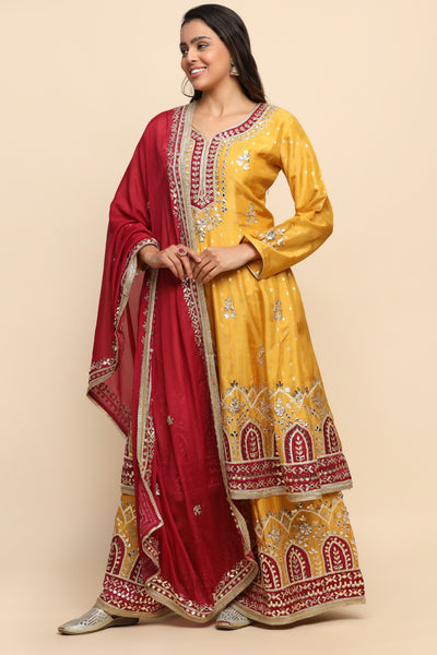 girl wearing a banarsi Mustard Color kurta with sharara