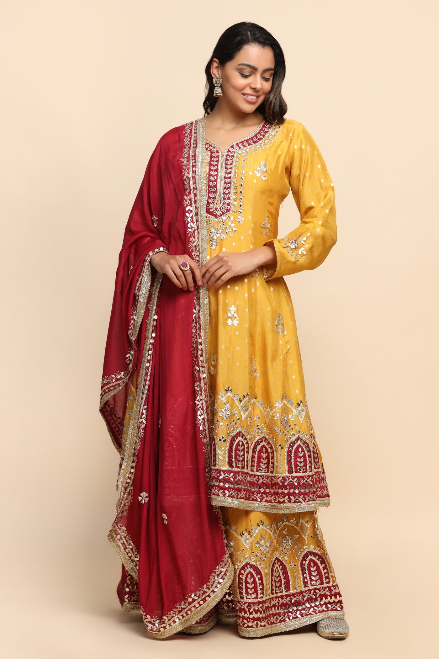 girl wearing a banarsi Mustard Color kurta with sharara