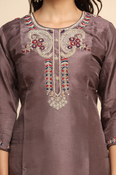 girl wearing a beautiful brown color floral motif embroidered suit