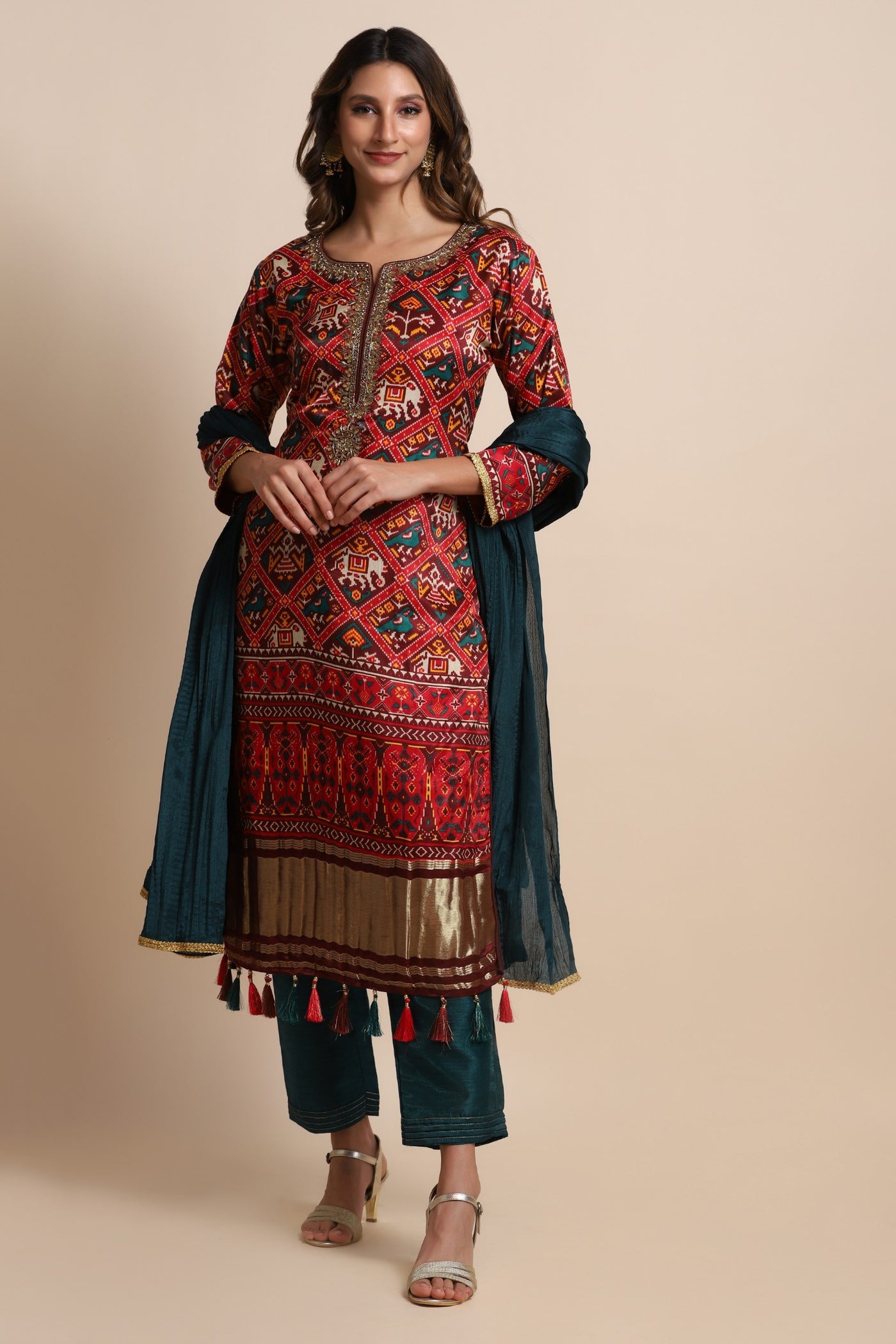 Red patola suit with embroidery on neckline paired with peacock blue pants and peacock blue dupatta