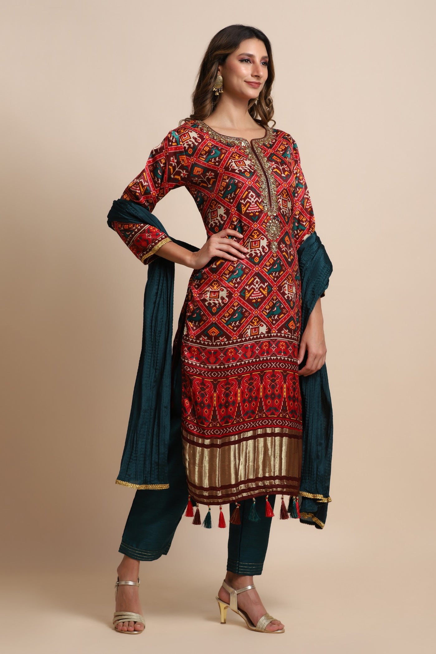 Red patola suit with embroidery on neckline paired with peacock blue pants and peacock blue dupatta