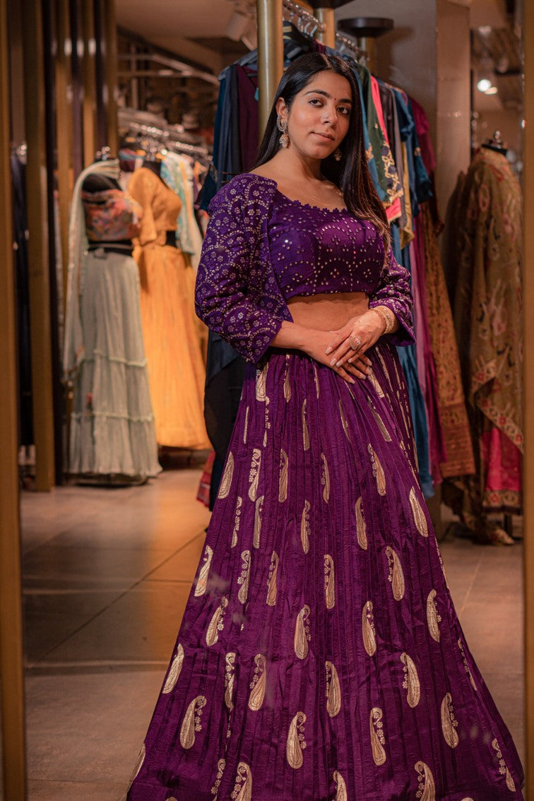 woman posing in purple paisley motif lehenga