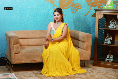 woman sitting wearing yellow flared sharara