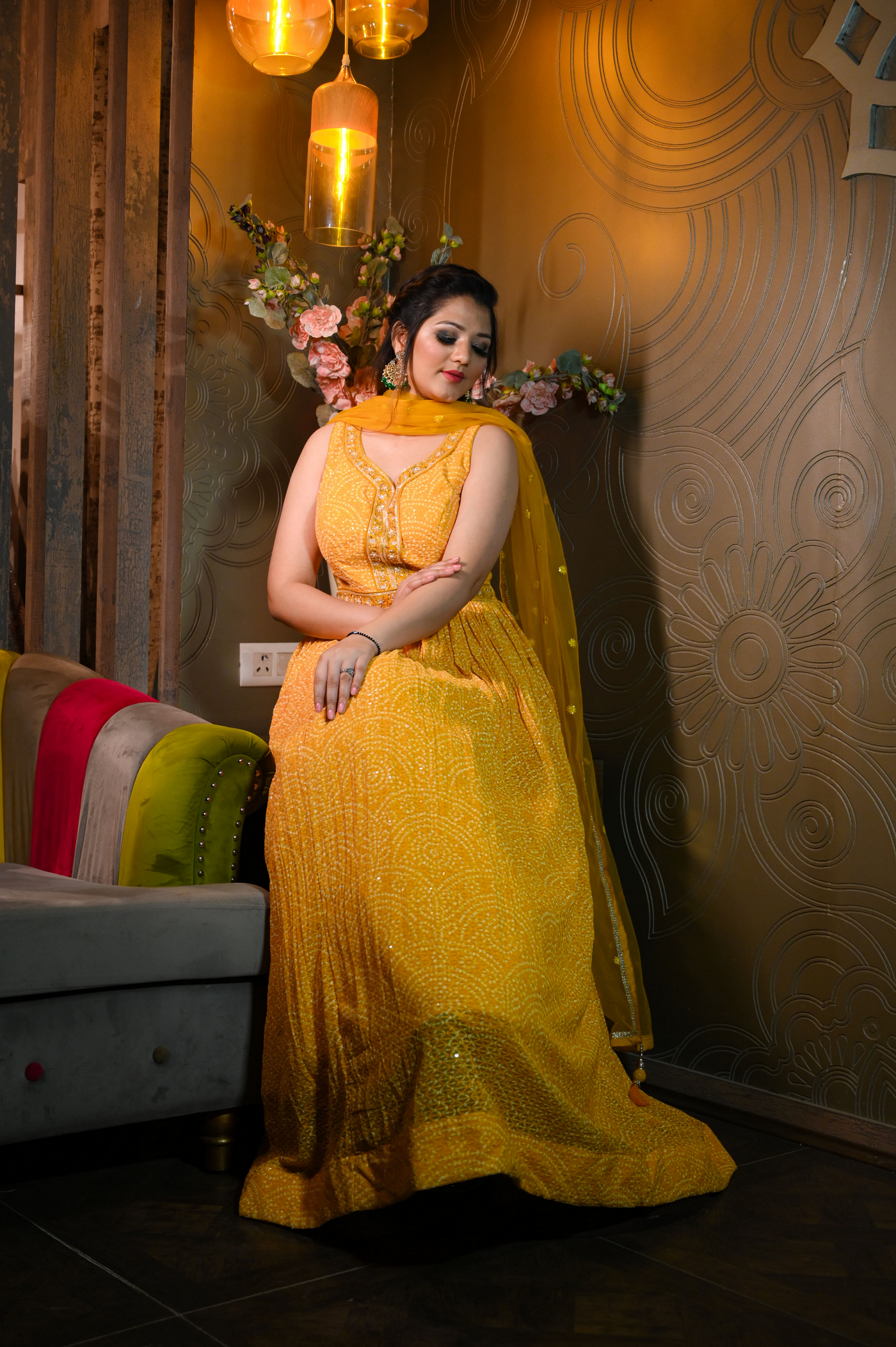 woman sitting wearing yellow bandhej dress